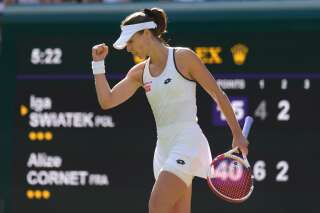 France's Alize Cornet celebrates breaking service in the second set against Poland's Iga Swiatek during a third round women's singles match on day six of the Wimbledon tennis championships in London, Saturday, July 2, 2022. (AP Photo/Kirsty Wigglesworth)