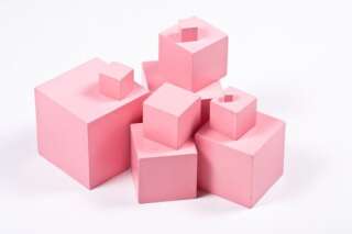 Montessori Pink Tower building blocks - sensorial material for elementary education. Isolated on white.