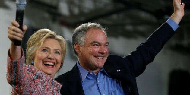Democratic U.S. presidential candidate Hillary Clinton and U.S. Senator Tim Kaine (D-VA) wave to the crowd during a campaign rally at Ernst Community Cultural Center in Annandale, Virginia, U.S., July 14, 2016.  REUTERS/Carlos Barria