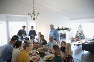 Multi-generation family enjoying Christmas dinner at table
