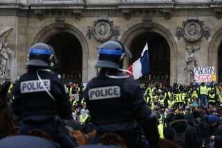 TOPSHOT - French mounted police stand in front protesters wearing yellow vests (gilets jaunes) during a demonstration against rising costs of living blamed on high taxes outside the Opera House in Paris, on December 15, 2018. - The 'Yellow Vests' (Gilets Jaunes) movement in France originally started as a protest about planned fuel hikes but has morphed into a mass protest against President's policies and top-down style of governing. (Photo by Geoffroy VAN DER HASSELT / AFP)        (Photo credit should read GEOFFROY VAN DER HASSELT/AFP/Getty Images)