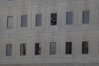 Un policier iranien à la fenêtre du bâtiment du Parlement iranien pendant la fusillade, le 7 juin.