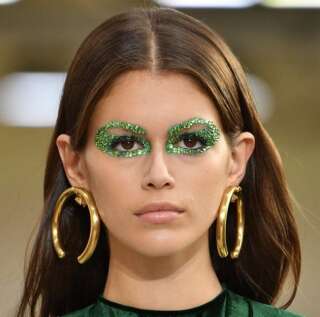 Kaia Gerber walking the runway with some very glittery eye makeup at the Valentino spring 2019 show in Paris.