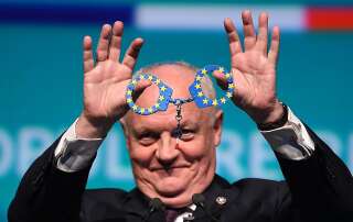 Head candidate of Popular Republican Union (UPR) party, François Asselineau shows mock handcuffs in the colours of the European flag during the first meeting to launch the campaign for the upcoming European Parliament elections, in Strasbourg, eastern France on April 5, 2019. (Photo by PATRICK HERTZOG / AFP)        (Photo credit should read PATRICK HERTZOG/AFP/Getty Images)
