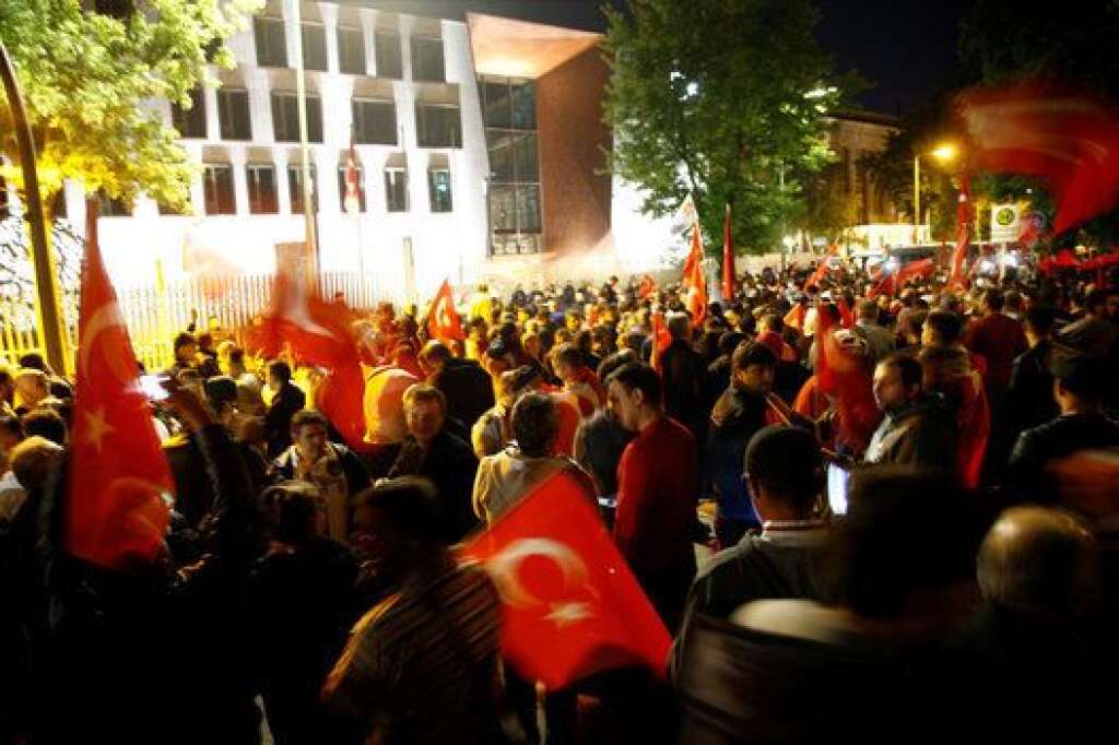 People with Turkish flags stand in front of the Turkish embassy in Berlin, Germany, July 16, 2016. REUTERS/Axel Schmidt