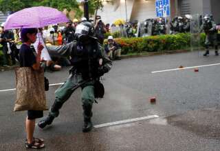Un agent de la police anti-émeute s’approche d’une manifestante lors d’un rassemblement à Tsuen Wan, le 25 août 2019.