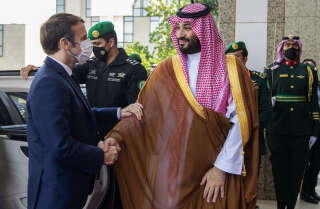 A handout picture provided by the Saudi Royal Palace shows Saudi Crown Prince Mohammed bin Salman (L) receiving French President Emmanuel Macron (R) in Saudi Arabia’s Red Sea coastal city of Jeddah on December 4, 2021.