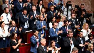 French far-right Rassemblement National's (RN) Members of parliament applaud the president of the party's parliamentary group after her speech following the Prime Minister's 