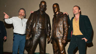 ALBUQUERQUE, NEW MEXICO - JULY 29: Actor Bryan Cranston (L) and actor Aaron Paul pose with bronze statues depicting television characters Walter White, played by Cranston, and Jesse Pinkman, played by Paul, from the series 