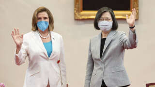 In this photo released by the Taiwan Presidential Office, U.S. House Speaker Nancy Pelosi, left, and Taiwanese President President Tsai Ing-wen wave during a meeting in Taipei, Taiwan, Wednesday, Aug. 3, 2022. U.S. House Speaker Nancy Pelosi, meeting top officials in Taiwan despite warnings from China, said Wednesday that she and other congressional leaders in a visiting delegation are showing they will not abandon their commitment to the self-governing island. (Taiwan Presidential Office via AP)