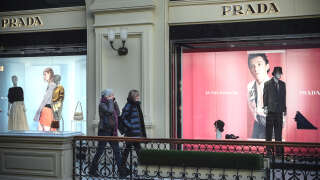 Women walk past a closed Prada shop in Moscow on March 10, 2022. - Many fashion and luxury brands have also announced the interruption of their activities in Russia, including Chanel, Hermes, Prada and LVMH. Luxury has been exempted from sanctions, but many groups have taken the decision to close their shops in the country. (Photo by AFP)