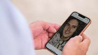 Paul Raoult, 63, the father of detained Sebastien Raoult, shows a phone bearing a portrait of his son in Epinal, eastern France, on August 1, 2022. - Morocco has detained Sebastien Raoult, a 21-year-old French national wanted by the US for alleged involvement in cybercrime, a police source in the kingdom told AFP on July 29, 2022, confirming media reports. Sebastien Raoult was taken in for questioning on May 31 at the Rabat-Sale airport in relation with an Interpol red notice over a cyber-piracy case. (Photo by Jean-Christophe Verhaegen / AFP)