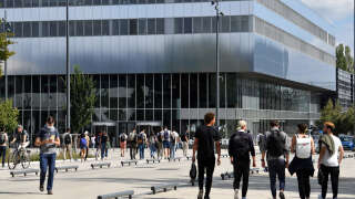 Students walk past the Paris-Saclay University in Saclay, on the outskirts of Paris, on September 17, 2021. (Photo by ALAIN JOCARD / AFP)