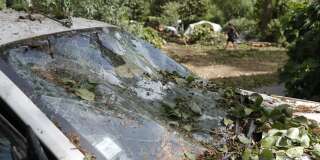 A destroyed car is parked in the Sagone camping site in Sagone, where a tree fell on a bungalow during storms killing one person on August 18, 2022, on the French Mediterranean island of Corsica. - The violent storms that have been hitting the French Mediterranean since August 16, 2022 left three people dead and several injured on August 18, 2022 in Corsica, where rescue operations are also being carried out at sea. (Photo by Pascal POCHARD-CASABIANCA / AFP)