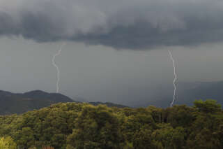 This picture taken on August 11, 2022, shows a lightning bolts during a storm over the Taravo valley, as the French Mediterranean island of Corsica is under storm warning. (Photo by Pascal Pochard-Casabianca / AFP)