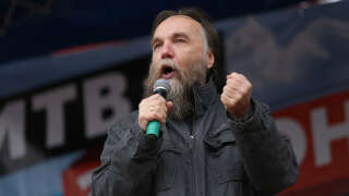 Russian politologist Alexander Dugin gestures as he addresses the rally 