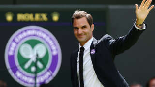 Swiss tennis player Roger Federer waves during the Centre Court Centenary Ceremony, on the seventh day of the 2022 Wimbledon Championships at The All England Tennis Club in Wimbledon, southwest London, on July 3, 2022. (Photo by Adrian DENNIS / AFP) / RESTRICTED TO EDITORIAL USE / “The erroneous mention[s] appearing in the metadata of this photo by Adrian DENNIS has been modified in AFP systems in the following manner: [Swiss tennis player Roger Federer] instead of [Swiss former tennis player Roger Federer]. Please immediately remove the erroneous mention[s] from all your online services and delete it (them) from your servers. If you have been authorized by AFP to distribute it (them) to third parties, please ensure that the same actions are carried out by them. Failure to promptly comply with these instructions will entail liability on your part for any continued or post notification usage. Therefore we thank you very much for all your attention and prompt action. We are sorry for the inconvenience this notification may cause and remain at your disposal for any further information you may require.”