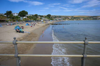 SWANAGE, ENGLAND - AUGUST 19: Beach goers are seen enjoying the weather at the beach, on August 19, 2022 in Swanage, United Kingdom. Swanage was named, on Wessex Water's website, as one of the beaches where sewage was discharged on WednesdayÂ August 17th. (Photo by Finnbarr Webster/Getty Images)