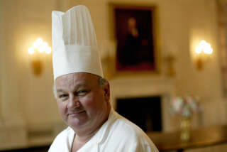 WASHINGTON, UNITED STATES:  FOR USE WITH USA-FRANCE-GASTRONOMY by Jerome BERNARD  White House pastry chef Roland Mesnier from Bonnay, France, poses in the State Dining Room of the White House 14 June, 2004, in Washington, DC. Mesnier, 60, announced he will retire from his post at the White House 30 July, 2004, after 25 years of service.   AFP PHOTO / TIM SLOAN  (Photo credit should read TIM SLOAN/AFP via Getty Images)