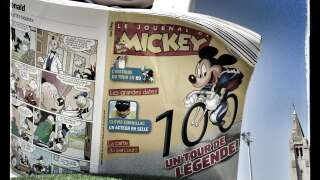 Image taken with a mobile phone shows Le Journal de Mickey vehicle belonging to the Tour de France advertising caravan in Bastia before the start of the 156 km second stage of the 100th edition of the Tour de France cycling race on June 30, 2013 between Bastia and Ajaccio, on the French Mediterranean Island of Corsica. AFP PHOTO / JOEL SAGET        (Photo credit should read JOEL SAGET/AFP via Getty Images)