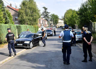 Police officers control a car in a street where a house belongs to Iman Hassan Iquioussen's family, in Lourches, northern France, on August 30, 2022. - The Conseil d'Etat (French Council of State) gave its green light on August 30, 2022 to the expulsion of the Iman Hassan Iquioussen decided by French Interior Minister Gerald Darmanin. (Photo by FRANCOIS LO PRESTI / AFP)