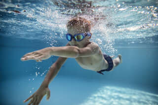Emmanuel Macron Portrait of little boy swimming underwater in the pool. Sunny summer day. Nikon D850