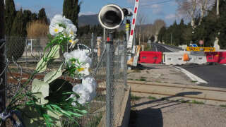 This general view shows flowers at a level crossing in Millas in southern France on February 21, 2018, 
where a schoolbus and a train collided in December 2017, killing six people. - The driver of the school bus involved in the collision with a regional train in December in Millas (Pyrénées-Orientales) has on February 21, 2018, maintained his version of the 