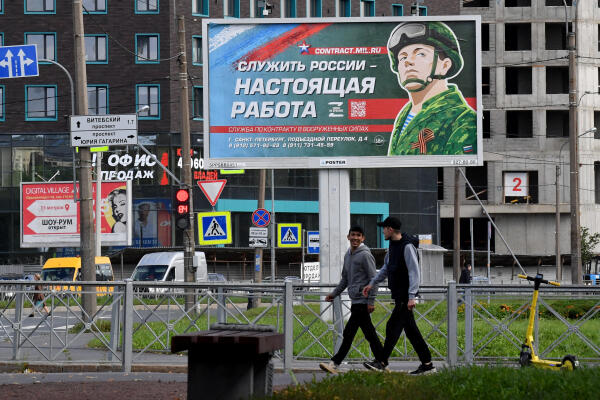 A billboard promoting contract army service with an image of a serviceman and the slogan reading "Serving Russia is a real job" sits in Saint Petersburg on September 20, 2022. (Photo by Olga MALTSEVA / AFP)