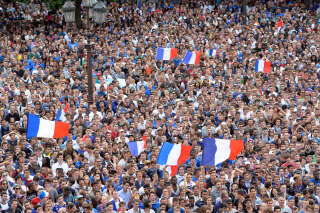 France's fans gather en masse to watch the 2014 FIFA World Cup quarter final football match between France and Germany on a giant screen at the Hotel de Ville (City Hall) in Paris on July 4, 2014. AFP PHOTO / MIGUEL MEDINA (Photo by Miguel MEDINA / AFP)