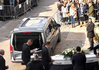 Funeral directors prepare the coffin at the entrance of the church prior to the funeral ceremony of the 12-year-old girl, known as Lola, whose body was found earlier this month stuffed into in a trunk in Paris, in Lillers, northern France on October 24, 2022. - The brutalised body of the victim, identified only as 