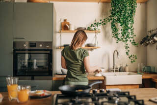 A woman doing the dishes after dinner.