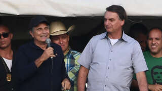 Brazilian President Jair Bolsonaro (R) and former F1 champion Nelson Piquet attend a demonstration by farmers against the Supreme Court and calling for the end of COVID-19 restrictions, in Brasilia, on May 15, 2021 - The rally's organizers have called for conservative 