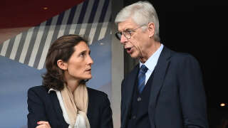 France's Sports Minister Amelie Oudea-Castera (L) and French FIFA Chief of Global Football Development and former player and coach Arsene Wenger speak in the tribunes prior to the   UEFA Nations League - League A Group 1 first leg football match between France and Denmark at the Stade de France in Saint-Denis, north of Paris, on June 3, 2022. (Photo by Franck FIFE / AFP)