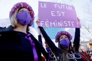 A Femen protester holds a palcard reading 'Futur is feminist' as they take part in a demonstration at the call of 