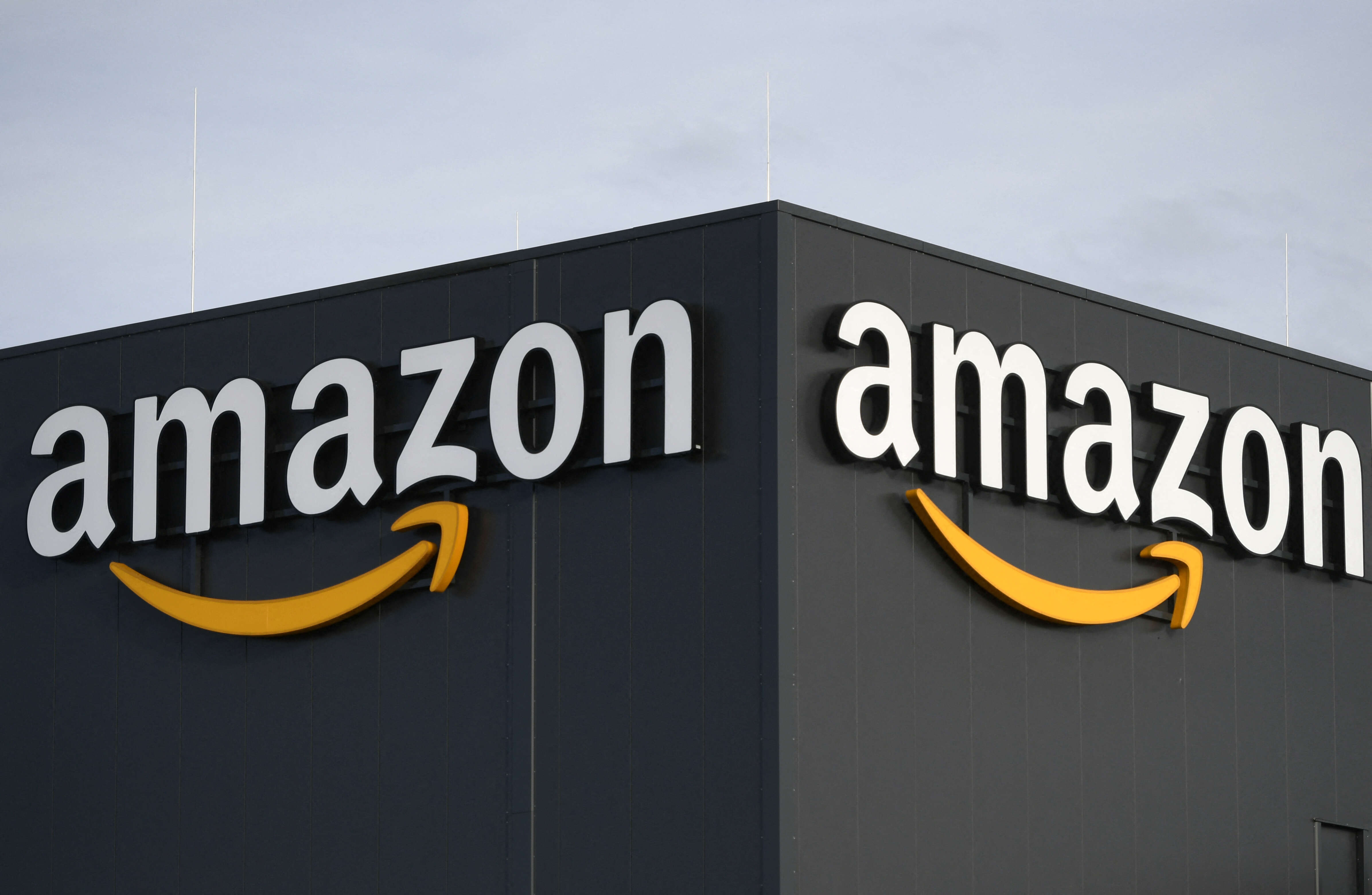 (FILES) In this file photo taken on December 17, 2019 this picture shows the logo of US online retail giant Amazon at the distribution center in Moenchengladbach, western Germany. - Amazon is preparing to lay off as many as 10,000 employees, The New York Times reported on November 15, 2022, making the e-commerce behemoth the latest tech giant to unleash a large-scale redundancy plan. (Photo by INA FASSBENDER / AFP)