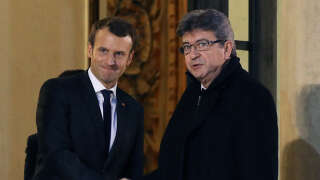 French leftist La France Insoumise (LFI) party leader Jean-Luc Melenchon (R) shakes hands with French President Emmanuel Macron as he leaves after their meeting at the Elysee palace in Paris, on November 21, 2017. (Photo by LUDOVIC MARIN / AFP)