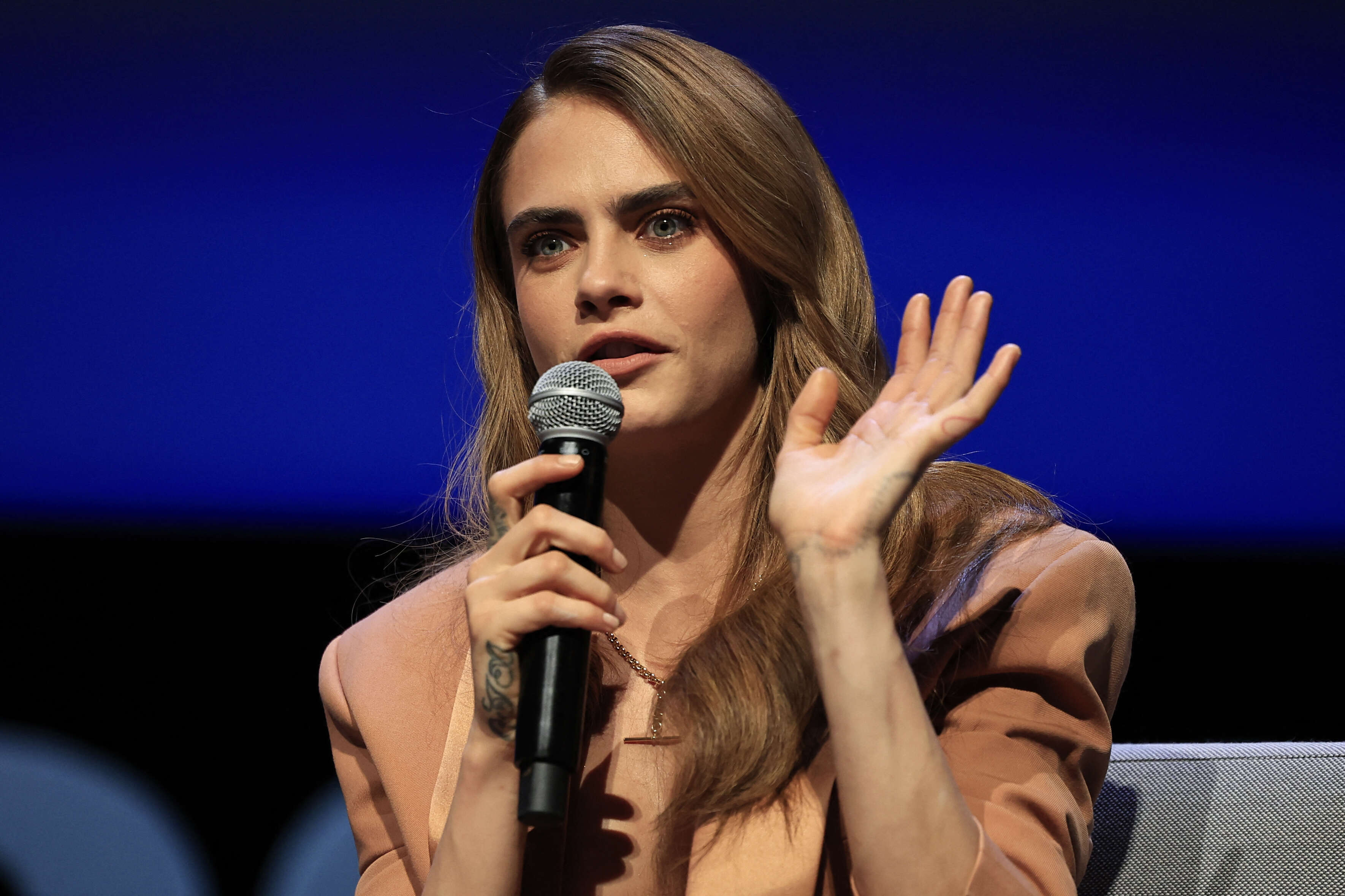 British model and actress Cara Delevingne talks as she attends the presentation of her documentary series 