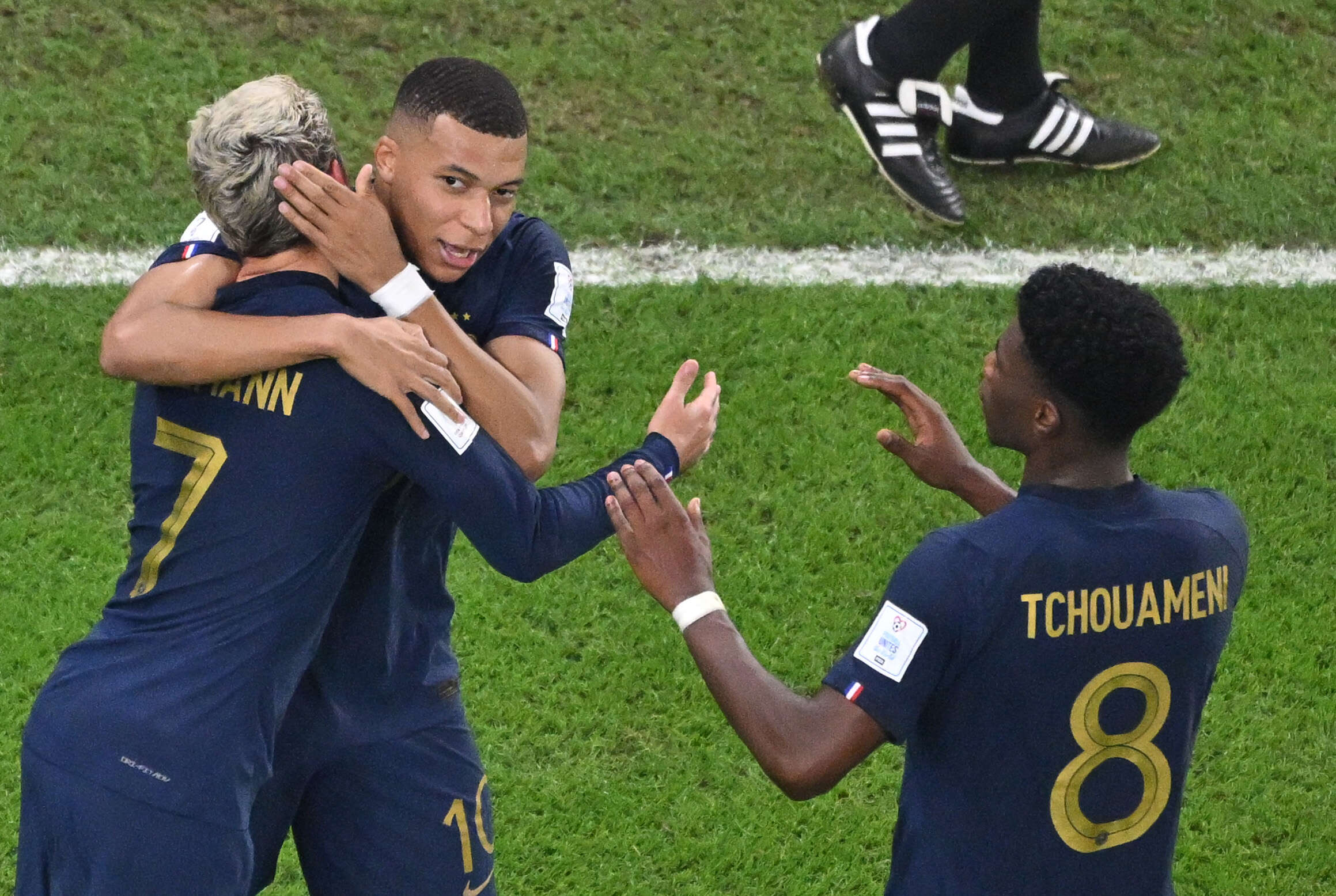 France's forward #07 Antoine Griezmann celebrates with France's forward #10 Kylian Mbappe and France's midfielder #08 Aurelien Tchouameni after scoring his team's first goal which was later disallowed after a VAR review for off-side during the Qatar 2022 World Cup Group D football match between Tunisia and France at the Education City Stadium in Al-Rayyan, west of Doha on November 30, 2022. (Photo by Antonin THUILLIER / AFP)