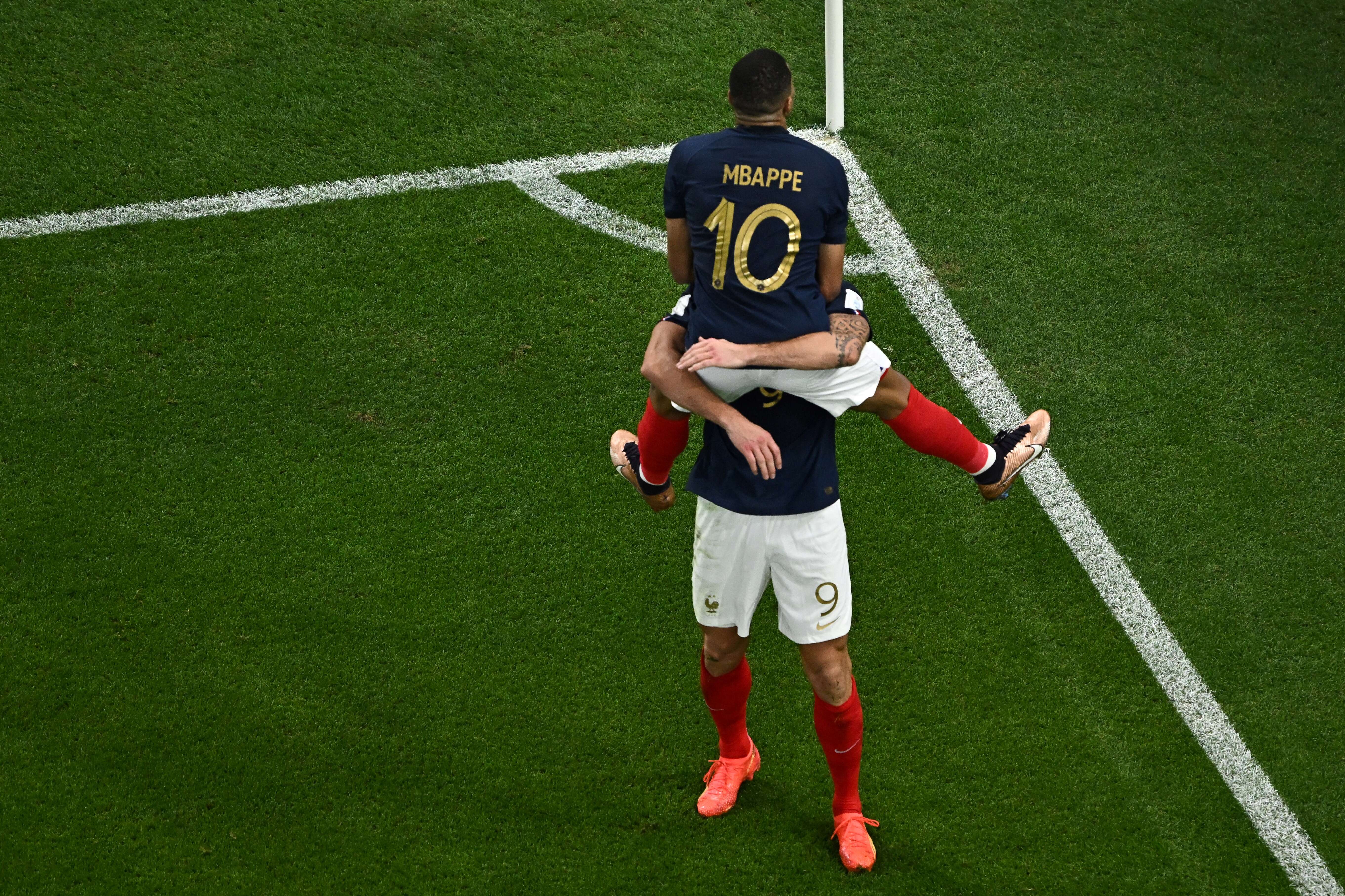 France's forward #09 Olivier Giroud (R) celebrates with France's forward #10 Kylian Mbappe after scoring his team's first goal during the Qatar 2022 World Cup round of 16 football match between France and Poland at the Al-Thumama Stadium in Doha on December 4, 2022. (Photo by MANAN VATSYAYANA / AFP)