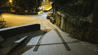 A photograph shows snow marks on the ground after snowfall in a street by night in Lyon, southeastern France, on December 13,2022.
