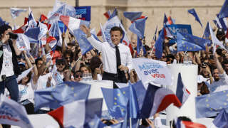 France's President and La Republique en Marche (LREM) candidate for re-election Emmanuel Macron wave supporters during an election campaign meeting in Marseille, southern France on April 16, 2022, ahead of the second round of voting in France's presidential election. (Photo by Ludovic MARIN / AFP)