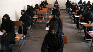Afghan female students take entrance exams at Kabul University in Kabul on October 13, 2022. (Photo by Wakil KOHSAR / AFP)