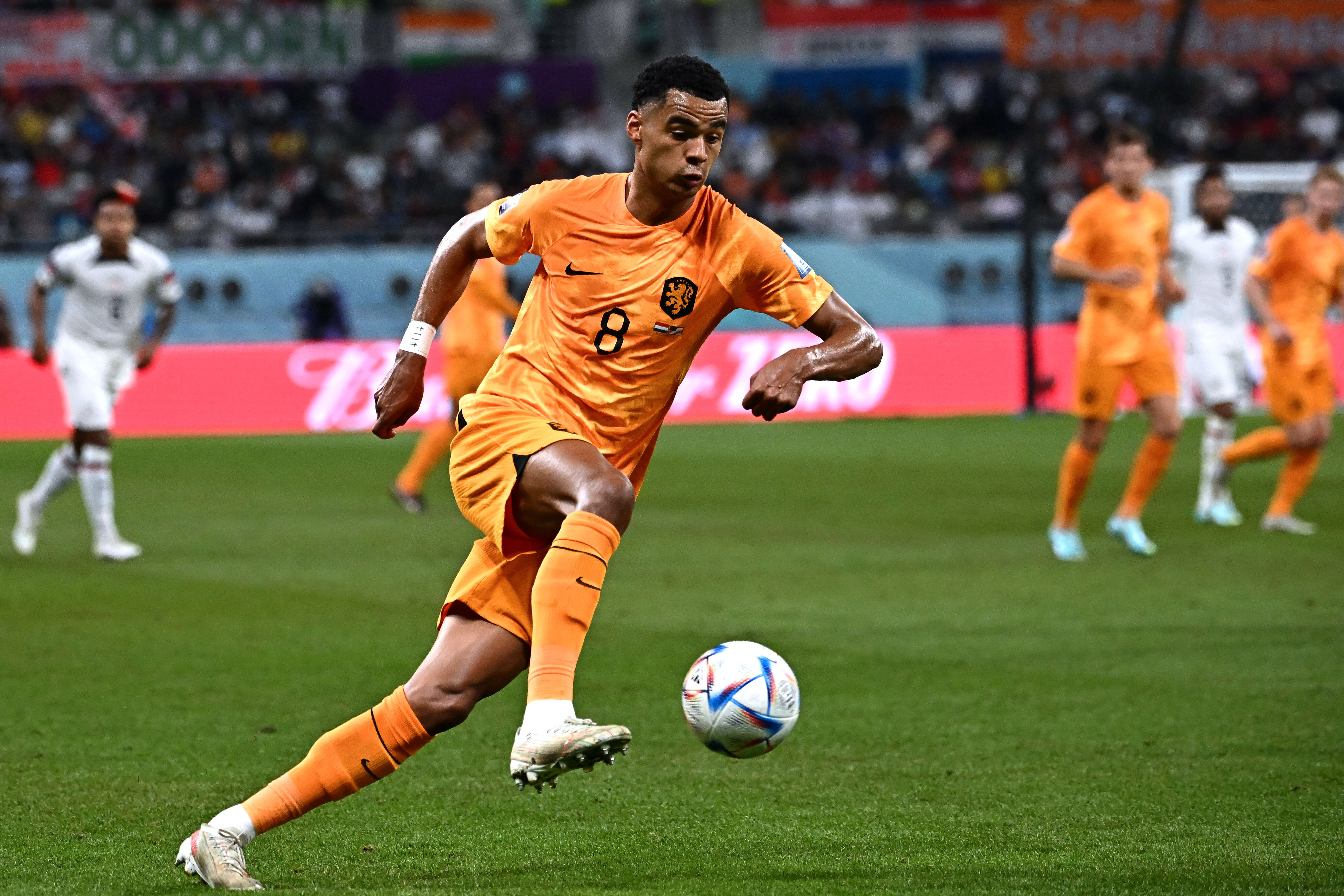 Netherlands' forward #08 Cody Gakpo runs with the ball during the Qatar 2022 World Cup round of 16 football match between the Netherlands and USA at Khalifa International Stadium in Doha on December 3, 2022. (Photo by Anne-Christine POUJOULAT / AFP)