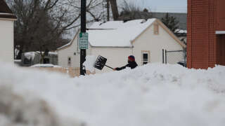 BUFFALO, NY - DECEMBER 28: A man clears his sidewalk along South Park Avenue on December 28, 2022 in Buffalo, New York. The historic Winter Storm Elliott dumped up to four feet of snow on the area leaving thousands without power and thirty confirmed dead in the city of Buffalo and the surrounding suburbs.   John Normile/Getty Images/AFP (Photo by John Normile / GETTY IMAGES NORTH AMERICA / Getty Images via AFP)