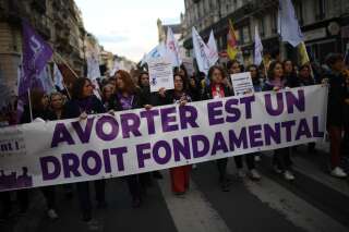 Demonstrators march behind a banner reading 'Abortion is fundamental right' as they take part in an abortion rights rally on the annual International Safe Abortion Day in Paris on September 28, 2022. (Photo by Christophe ARCHAMBAULT / AFP) (Photo by CHRISTOPHE ARCHAMBAULT/AFP via Getty Images)