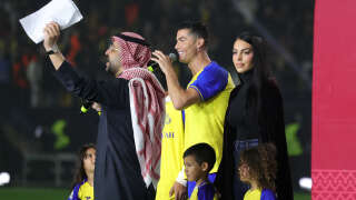 Al-Nassr's new Portuguese forward Cristiano Ronaldo (C), his partner Georgina Rodriguez (2nd-L) and his children stand on the stage during his unveiling at the Mrsool Park Stadium in the Saudi capital Riyadh on January 3, 2023. (Photo by Fayez Nureldine / AFP)