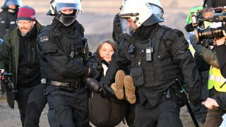 Police officers carry Swedish climate activist Greta Thunberg (C) out of a group of demonstrators and activists in Erkelenz, western Germany, on January 17, 2023, as demonstrations continue against a coal mine extension in the nearby village of Luetzerath. - Already abandoned by its original residents, Luetzerath has become a symbol for resistance against fossil fuels. Energy giant RWE has permission for the expansion of the mine under a compromise agreement that also includes that RWE will stop producing electricity with coal in western Germany by 2030 -- eight years earlier than previously planned. With Russia's gas supply cut in the wake of the invasion of Ukraine, Germany has had recourse to coal, firing up mothballed power plants. (Photo by Federico Gambarini / dpa / AFP) / Germany OUT