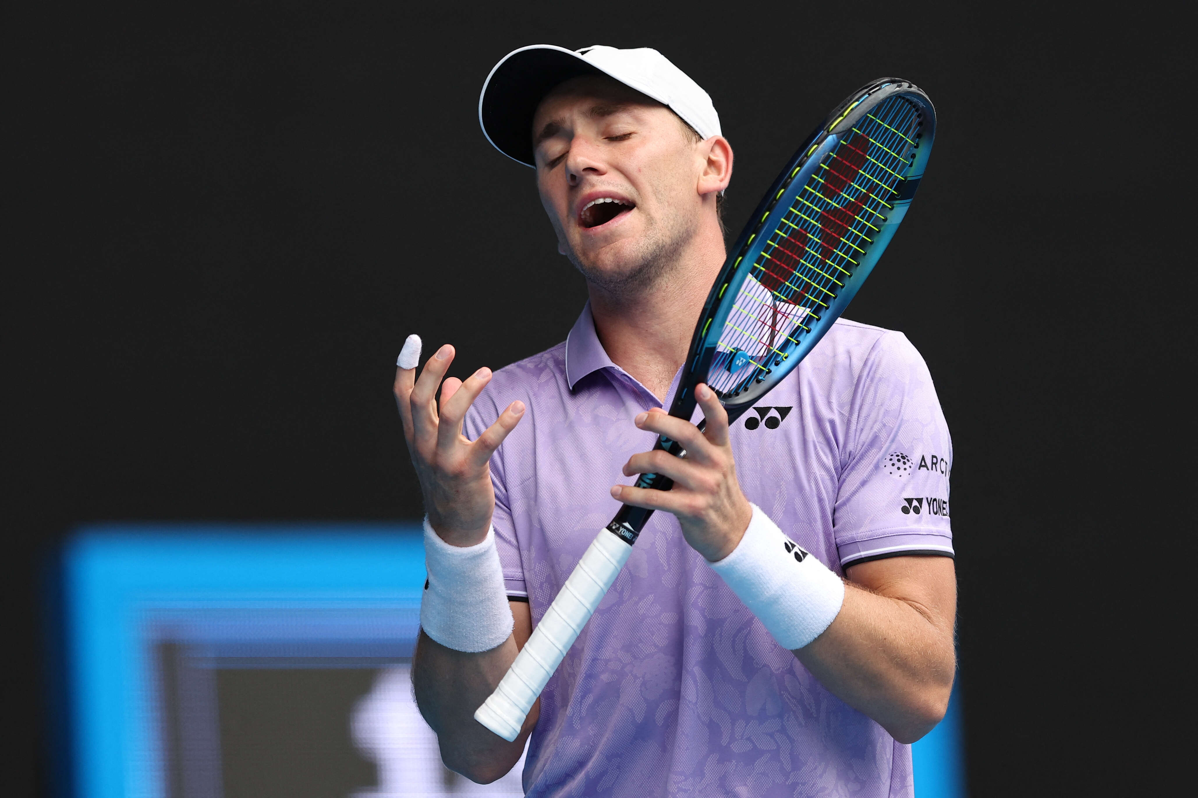 Norway's Casper Ruud reacts as he plays against USA's Jenson Brooksby during their men's singles match on day four of the Australian Open tennis tournament in Melbourne on January 19, 2023. (Photo by Martin KEEP / AFP) / -- IMAGE RESTRICTED TO EDITORIAL USE - STRICTLY NO COMMERCIAL USE --