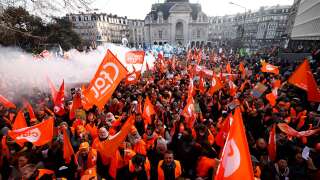 Demonstrators wave union flags during a rally called by French trade unions in Lille, northern France on January 19, 2023, as workers go on strike over the French President's plan to raise the legal retirement age from 62 to 64.. - A day of strikes and protests kicked off in France on January 19, set to disrupt transport and schooling across the country in a trial for the government as workers oppose a deeply unpopular pensions overhaul. (Photo by Sameer Al-Doumy / AFP)