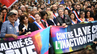2022 Nobel Prize in Literature laureate French novelist Annie Ernaux (6th from left), Founder of La France Insoumise (LFI) and member of the left-wing NUPES (New People's Ecological and Social Union) coalition Jean-Luc Melenchon (4th from right), former New Anti-Capitalist Party candidate Philippe Poutou (left) attends a rally against soaring costs of living and climate inertia called for by France's left-wing coalition NUPES (New People's Ecological and Social Union) in Paris on October 16, 2022. (Photo by Christophe ARCHAMBAULT / AFP)